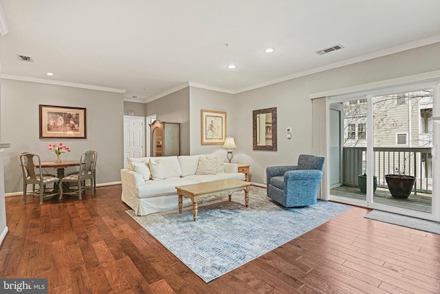 living room featuring dark wood-style flooring, visible vents, and baseboards