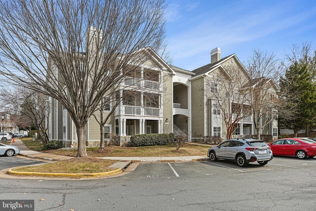 view of property featuring uncovered parking