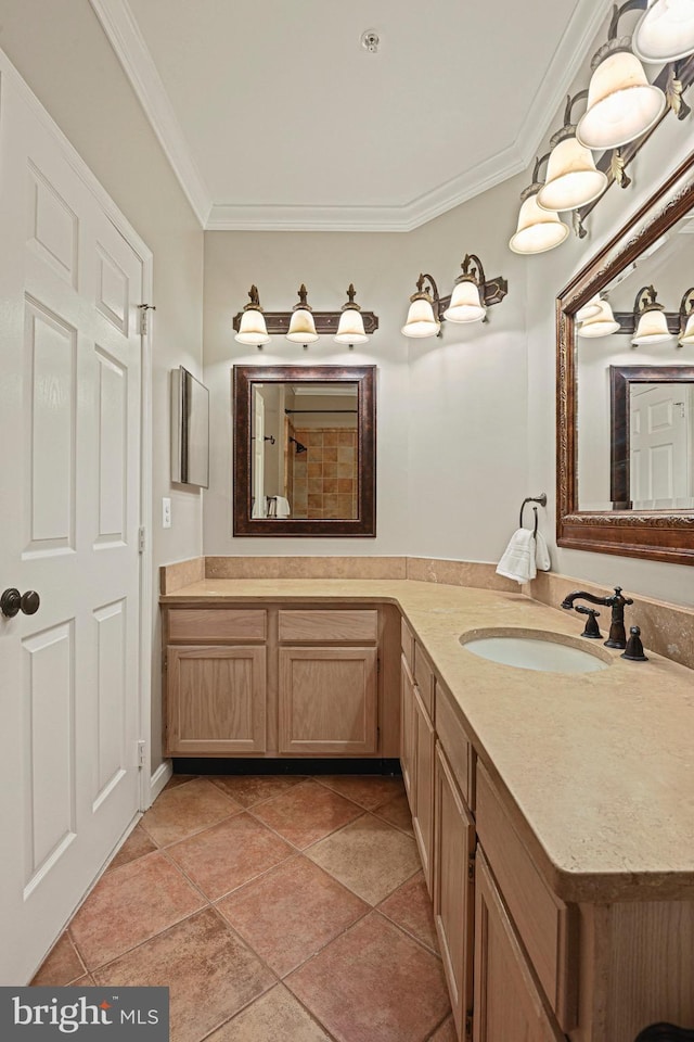 bathroom with double vanity, crown molding, a sink, and tile patterned floors