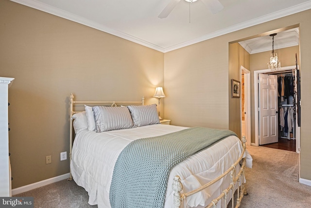 carpeted bedroom featuring ceiling fan, ornamental molding, and baseboards