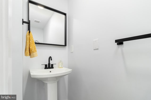 bathroom featuring visible vents and a sink