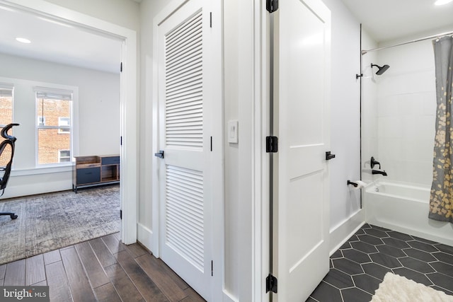 full bath with shower / tub combo, recessed lighting, wood finished floors, and baseboards