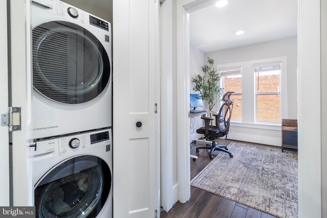 laundry room with laundry area, recessed lighting, stacked washer / drying machine, and dark wood-type flooring