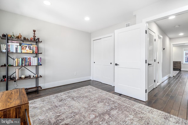 interior space featuring recessed lighting, visible vents, baseboards, and wood finished floors