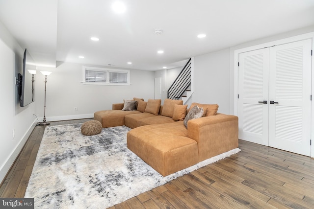 living area with recessed lighting, wood finished floors, and baseboards