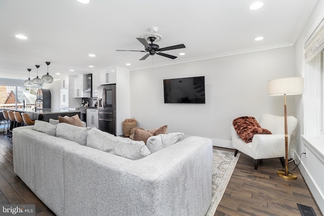 living room featuring recessed lighting, dark wood-type flooring, and crown molding