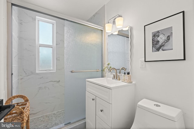 bathroom with vanity, toilet, and a shower with shower door