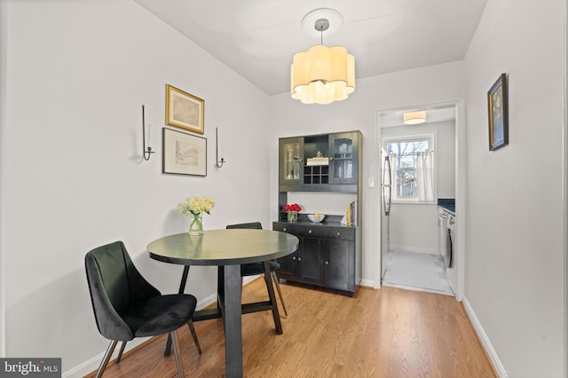 dining room featuring an inviting chandelier and light hardwood / wood-style flooring