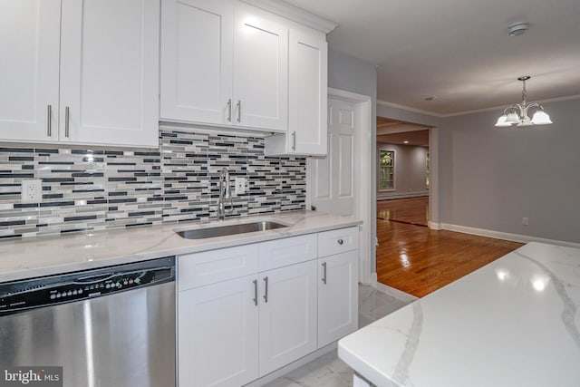 kitchen featuring sink, stainless steel dishwasher, white cabinetry, and light stone countertops