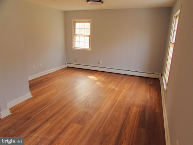 spare room with light hardwood / wood-style floors and a baseboard radiator