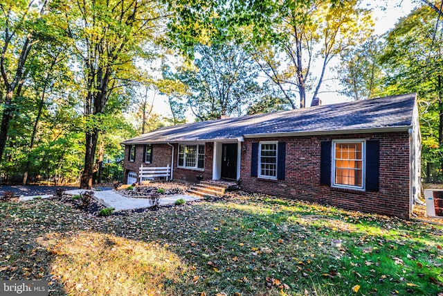 ranch-style house with a front yard and a garage