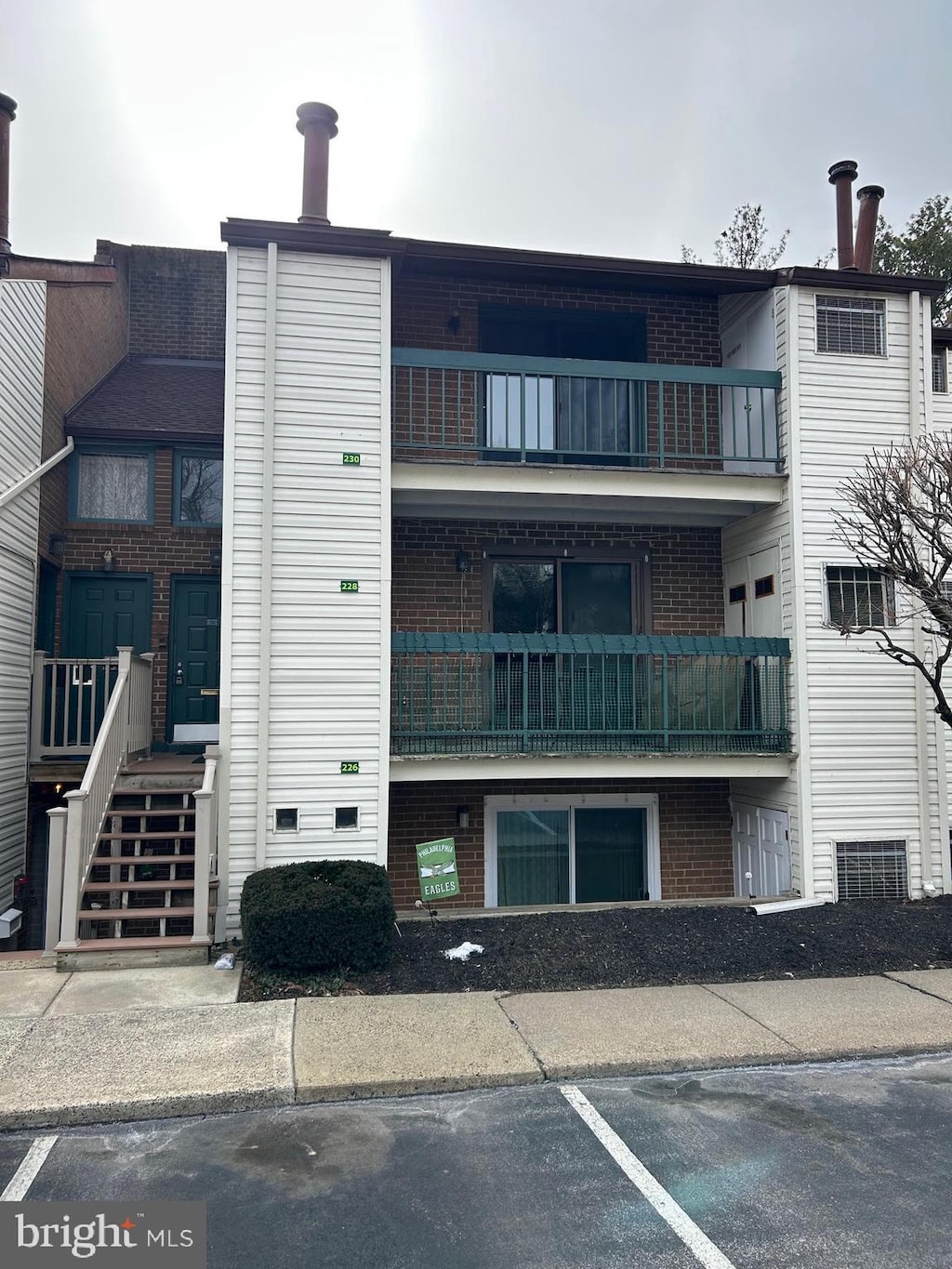 view of building exterior with uncovered parking