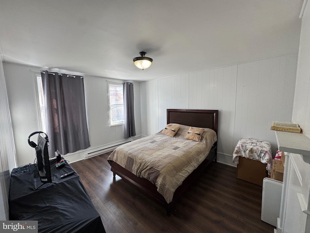 bedroom featuring dark wood-style floors and a baseboard radiator