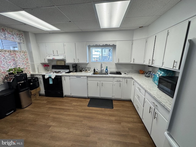 kitchen with dishwasher, electric stove, freestanding refrigerator, light countertops, and under cabinet range hood