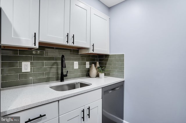 kitchen with white cabinetry, sink, and black dishwasher