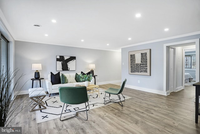 living room featuring ornamental molding and light wood-type flooring