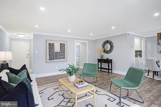 living room with light hardwood / wood-style flooring and crown molding