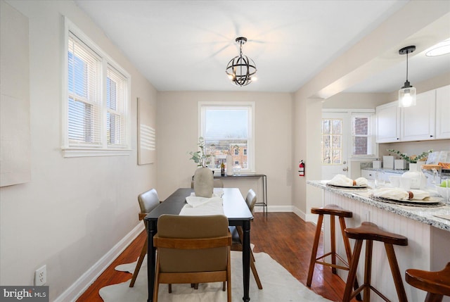 dining room featuring a chandelier and dark hardwood / wood-style floors