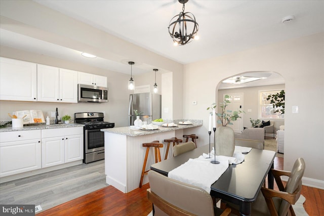 dining room featuring light hardwood / wood-style floors and an inviting chandelier