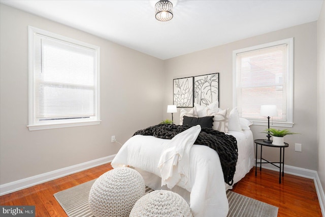 bedroom featuring multiple windows and hardwood / wood-style floors