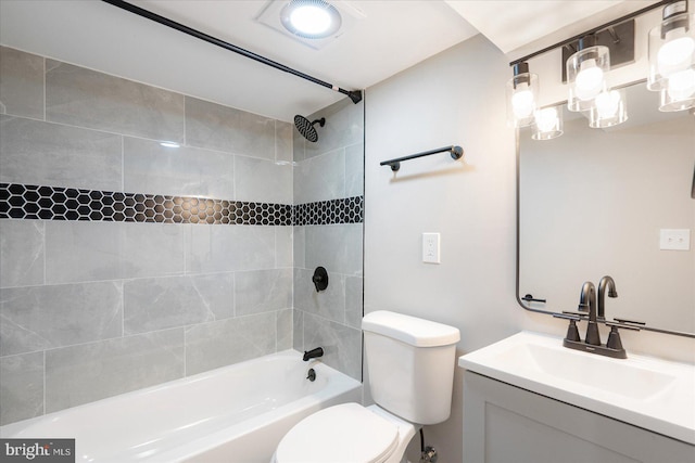 full bathroom featuring tiled shower / bath combo, vanity, and toilet