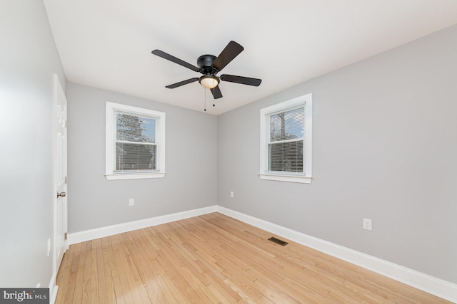 unfurnished room with baseboards, ceiling fan, visible vents, and light wood finished floors