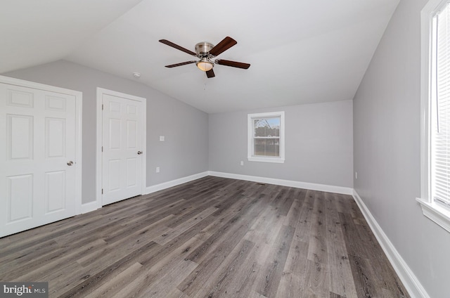 bonus room with a ceiling fan, baseboards, vaulted ceiling, and wood finished floors