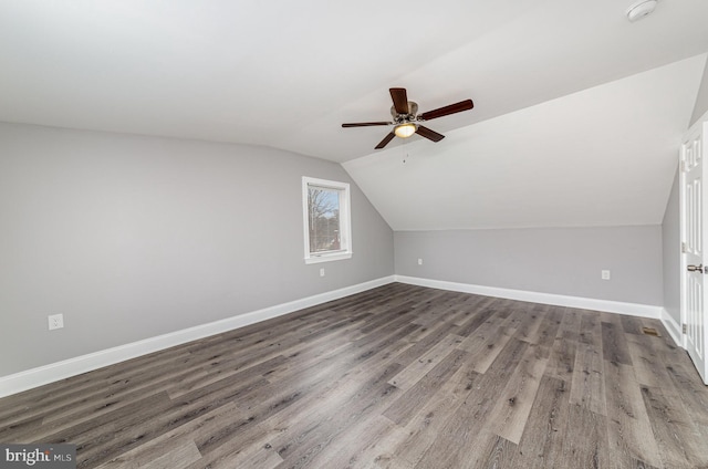 additional living space featuring lofted ceiling, ceiling fan, baseboards, and wood finished floors