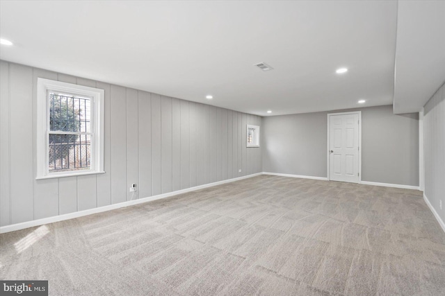 basement featuring light carpet