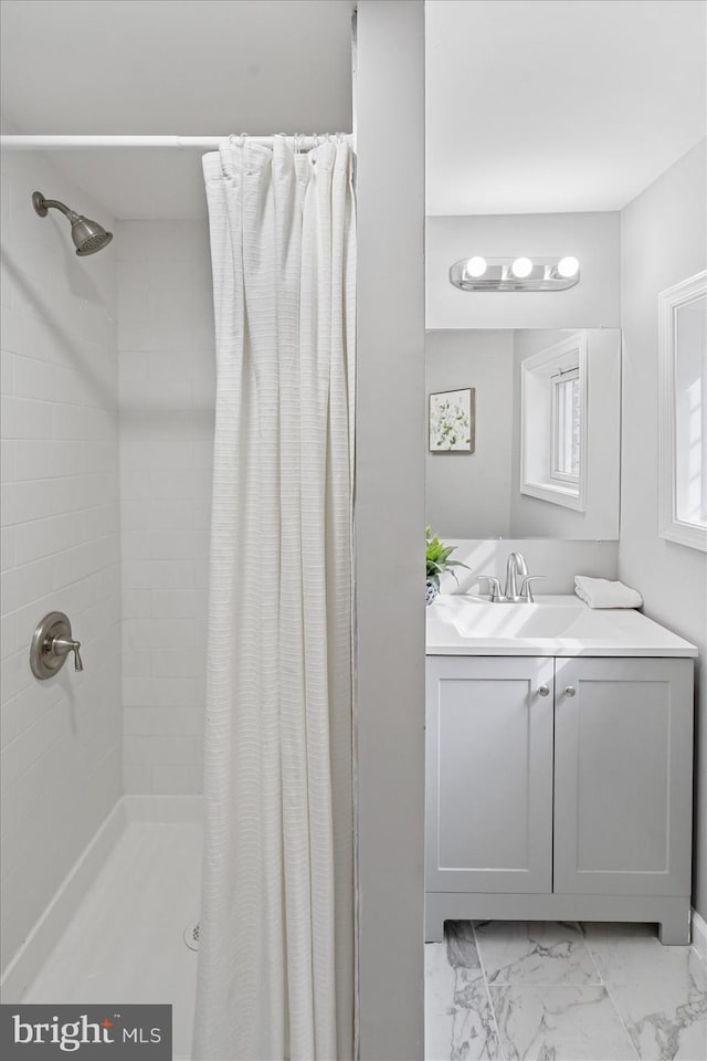 bathroom with sink and a shower with shower curtain