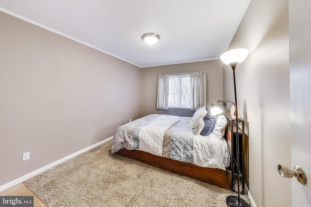 bedroom with baseboards and crown molding