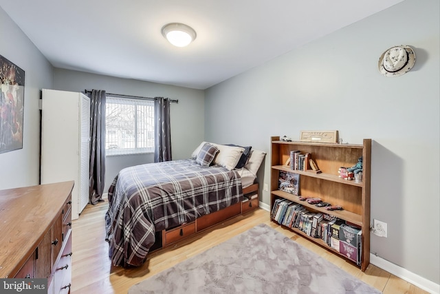 bedroom featuring light wood-type flooring and baseboards