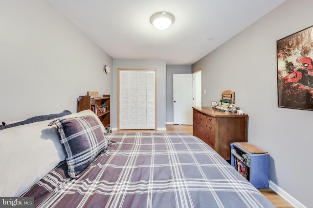 bedroom featuring baseboards and wood finished floors