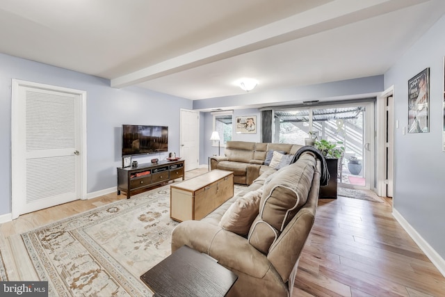 living area featuring light wood-style flooring and baseboards