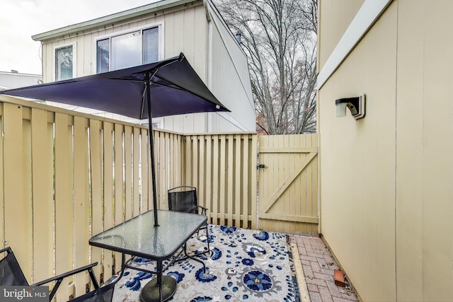 view of patio featuring a gate and fence