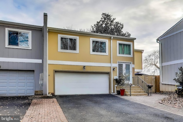 multi unit property featuring a garage and driveway