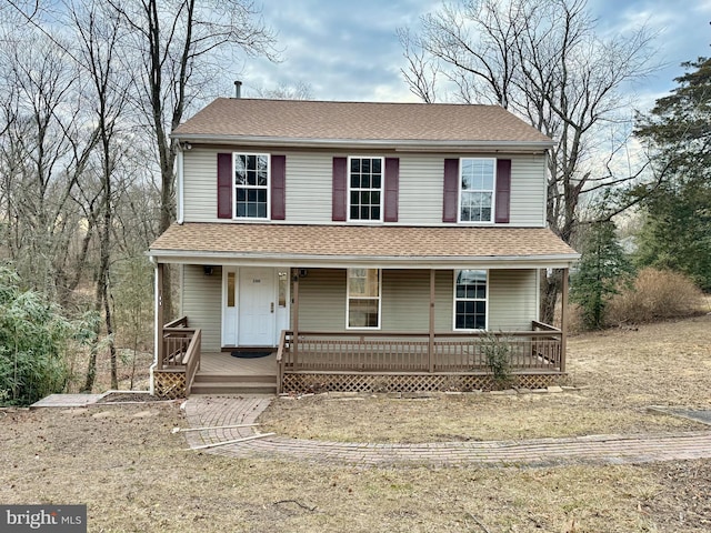 view of front of home with covered porch and roof with shingles