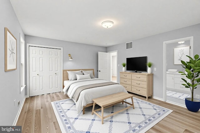 bedroom with baseboards, visible vents, a closet, and light wood-type flooring