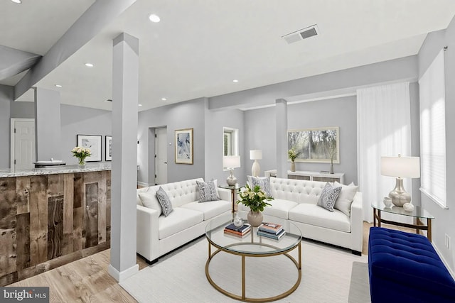 living area featuring visible vents, recessed lighting, and wood finished floors