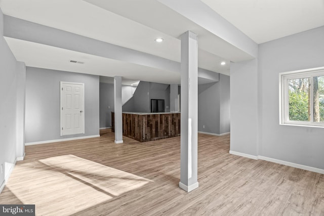 below grade area with recessed lighting, baseboards, and wood finished floors