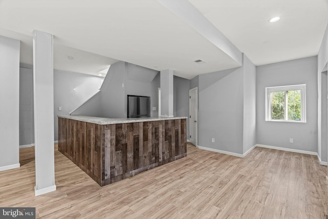 kitchen with visible vents, baseboards, and wood finished floors