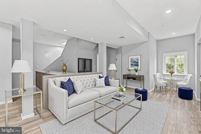 living area with visible vents, recessed lighting, light wood-style floors, and baseboards