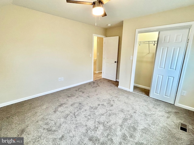 unfurnished bedroom with baseboards, visible vents, a ceiling fan, carpet floors, and a closet