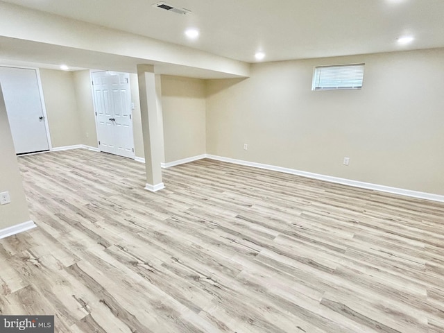 basement with light wood-type flooring, baseboards, visible vents, and recessed lighting