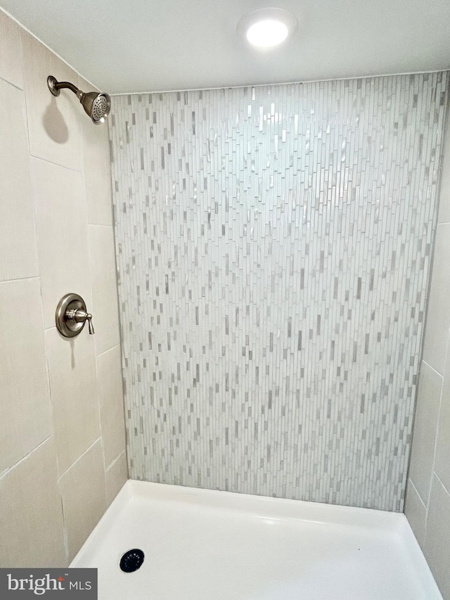 full bathroom with a tile shower