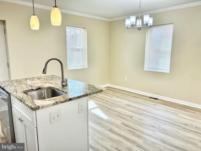 kitchen with crown molding, light wood finished floors, a sink, dishwasher, and baseboards