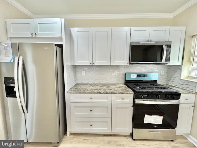 kitchen featuring stainless steel appliances, light wood-style floors, ornamental molding, white cabinets, and light stone countertops