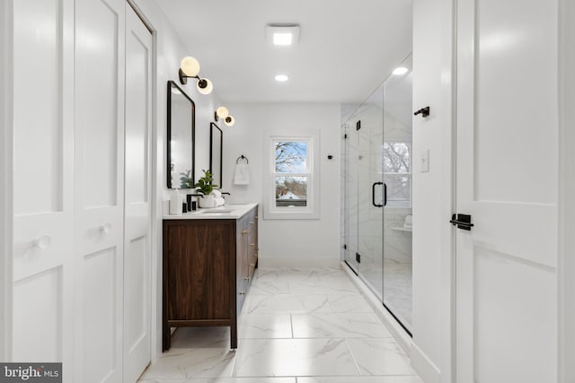 full bath featuring recessed lighting, vanity, baseboards, marble finish floor, and a stall shower