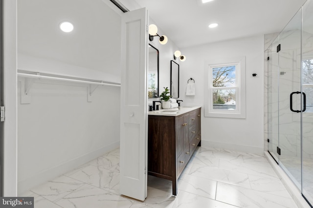 bathroom featuring marble finish floor, recessed lighting, a marble finish shower, and baseboards