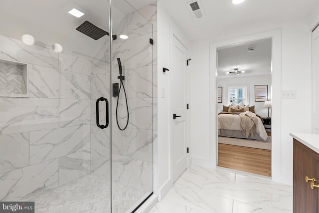 bathroom featuring marble finish floor, a marble finish shower, visible vents, and connected bathroom